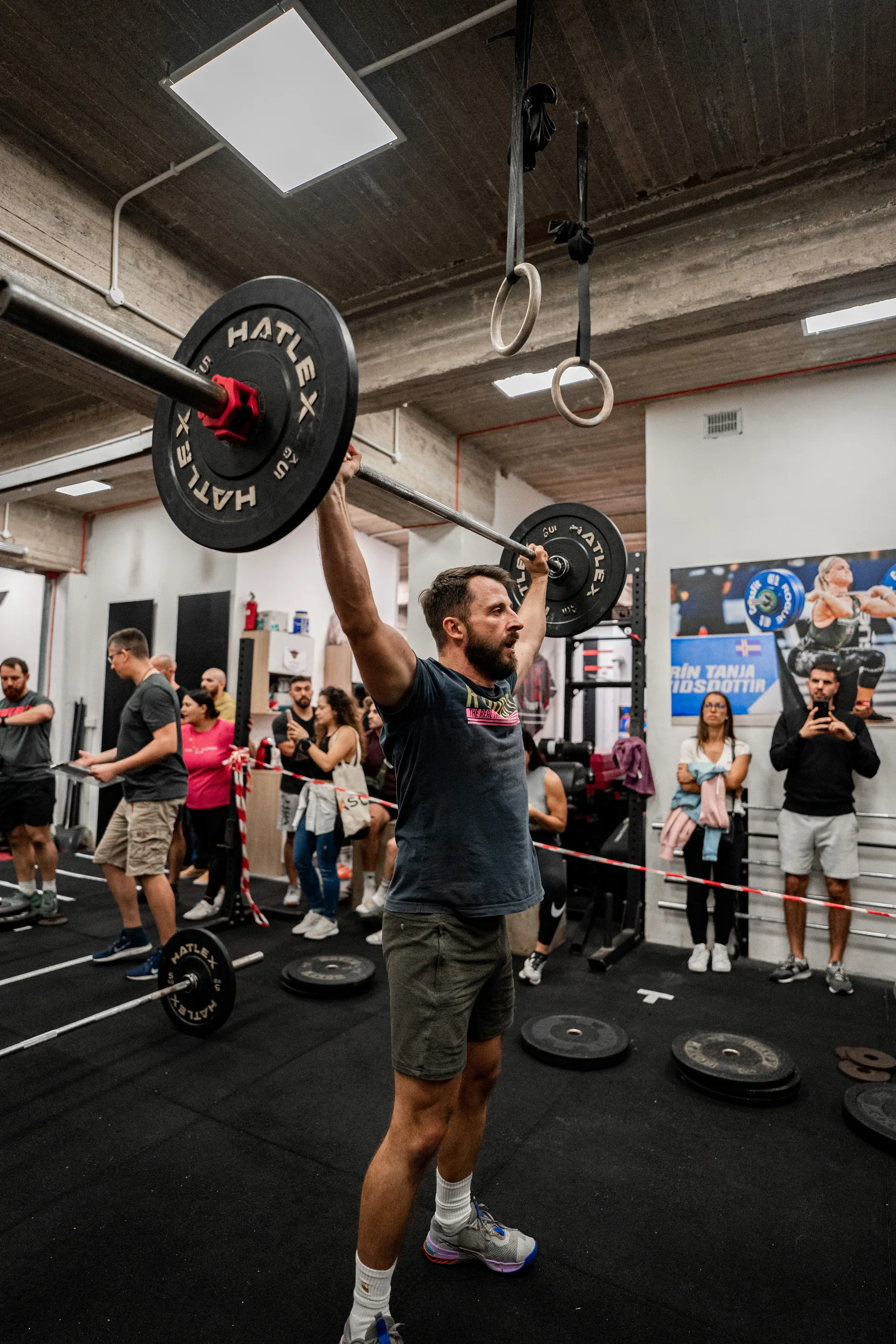 Athlete pressing barbell overhead during functional fitness competition at F15 Training CENTR Malta